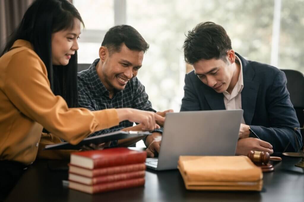 paralegal helping a client on a computer