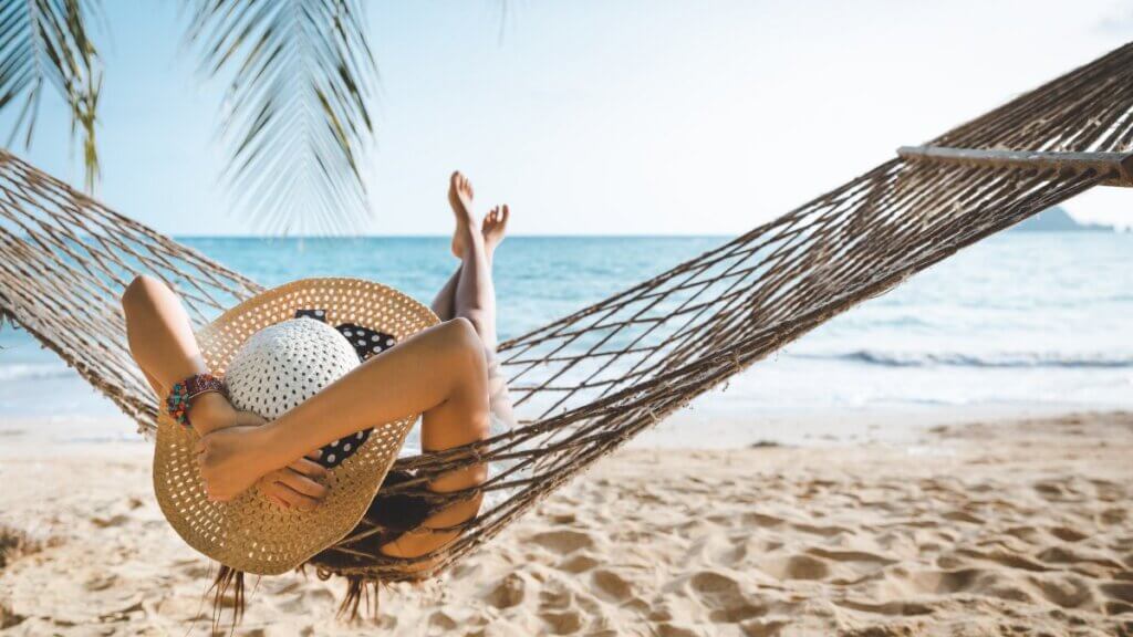 Woman sitting in a hammock on vacation